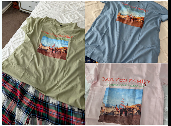 An image showing three custom-printed t-shirts in different colors: olive green, light blue, and pale pink. Each shirt features the same "Carlyon Family European Christmas 2024" design, which includes a photo of a horse-drawn carriage in a festive European square with a large Christmas tree, topped with a small red Santa hat graphic.