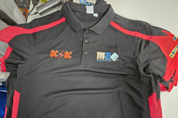 Black shirts embroidered for company event on left and right chest