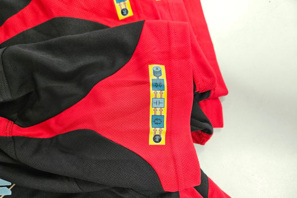 DTF print on left sleeve of Talon polo shirt