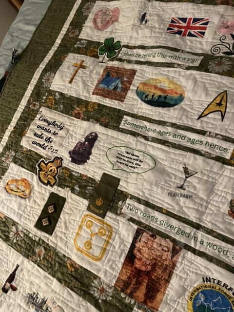 Close view of printed quilt patches with personal messages military memorabilia and photographs